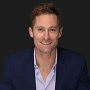 Modern professional portrait of a smiling man in business attire, ideal for corporate or marketing websites.