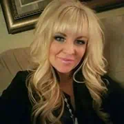 Elegant woman with blonde hair smiling, professional portrait for Stack Mode Marketing Group branding.