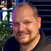 Smiling man with a friendly expression, professional headshot for Stack Mode Marketing Group.