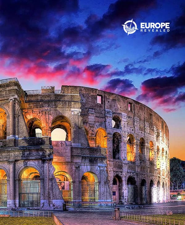 Ancient Roman Colosseum at sunset with vibrant sky, illuminated arches, historic architecture, and twilight colors, showcasing Italy's iconic monument and cultural heritage.